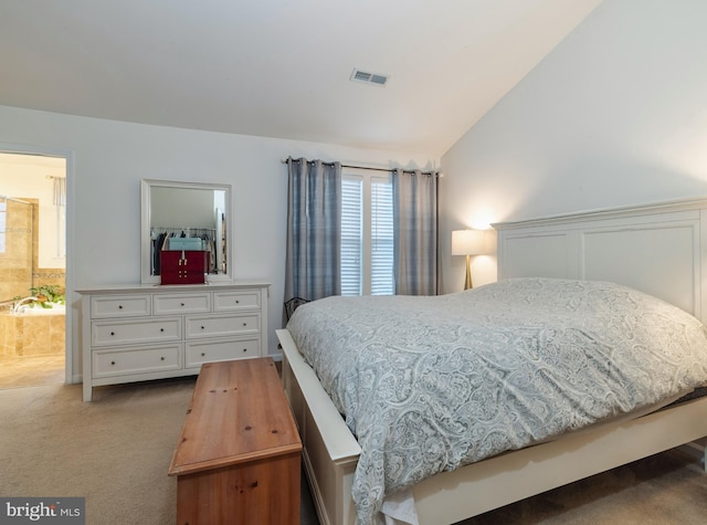 bedroom with light colored carpet and lofted ceiling