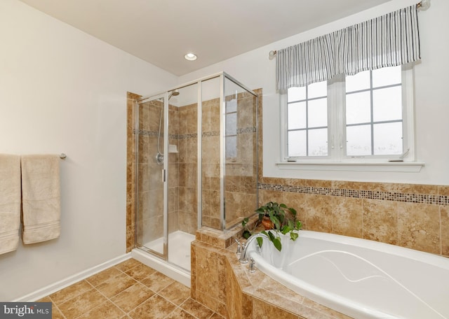 bathroom featuring tile patterned flooring and separate shower and tub