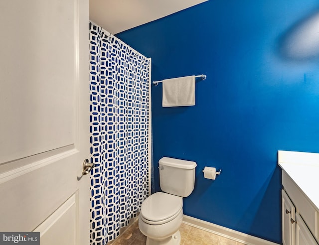 bathroom featuring vanity, toilet, and tile patterned flooring