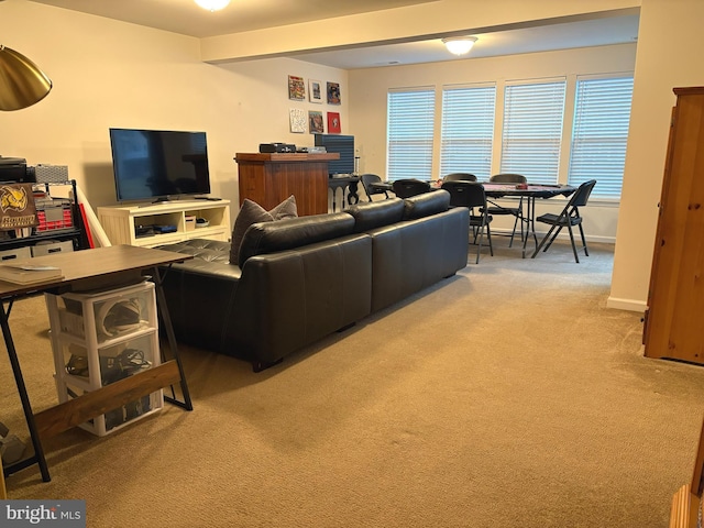 living room with light carpet and beam ceiling