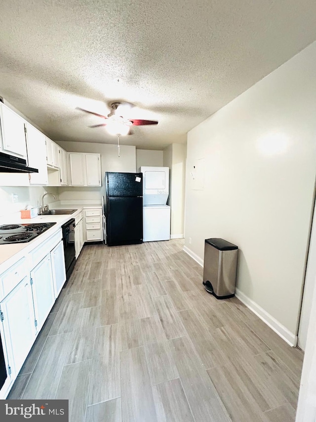 kitchen with sink, ceiling fan, black appliances, white cabinets, and light wood-type flooring