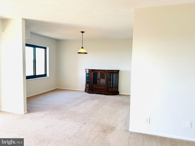 unfurnished room featuring carpet floors and a textured ceiling