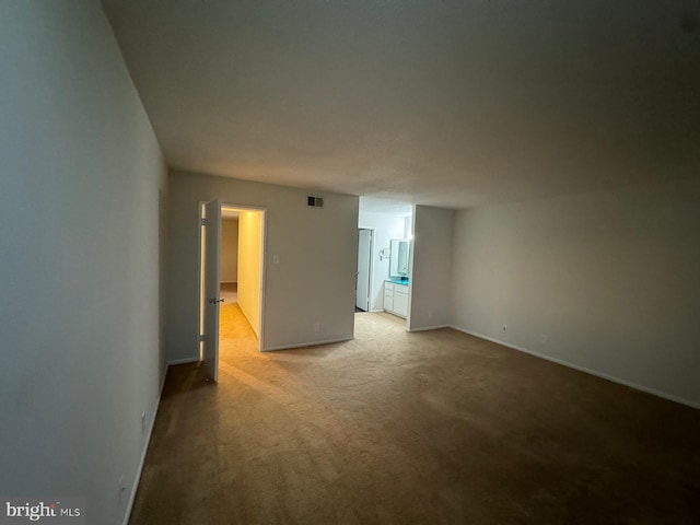 unfurnished room with light colored carpet