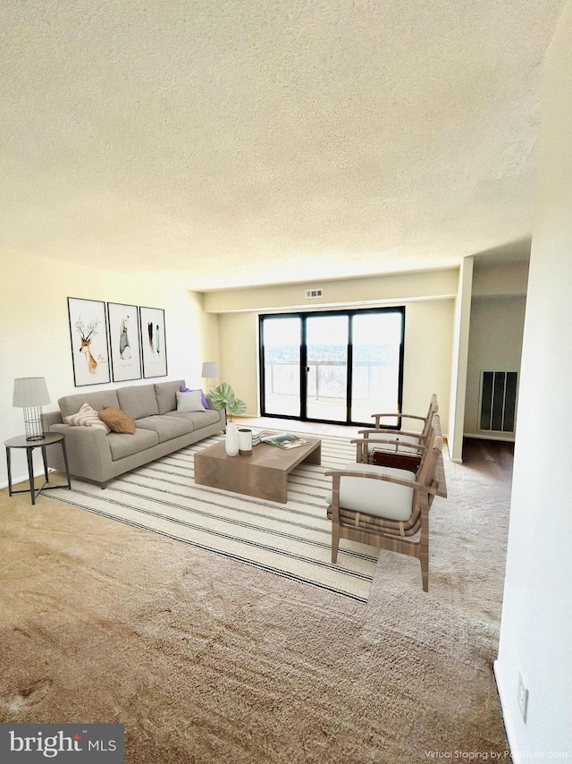 carpeted living room featuring a textured ceiling