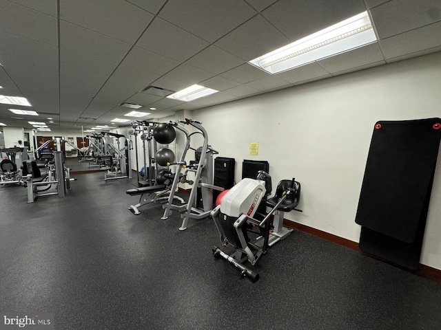 gym with a paneled ceiling