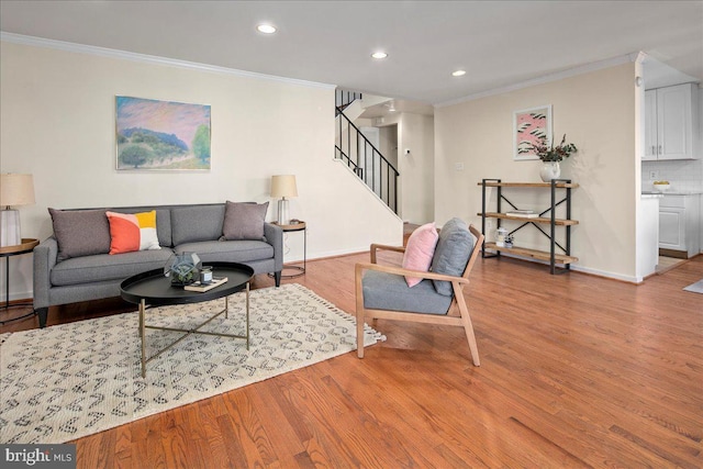 living room featuring light hardwood / wood-style floors and crown molding