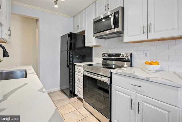 kitchen with appliances with stainless steel finishes, white cabinetry, ornamental molding, and sink