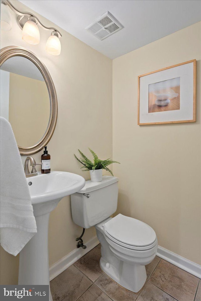 bathroom with toilet and tile patterned flooring