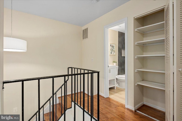 hall with hardwood / wood-style floors