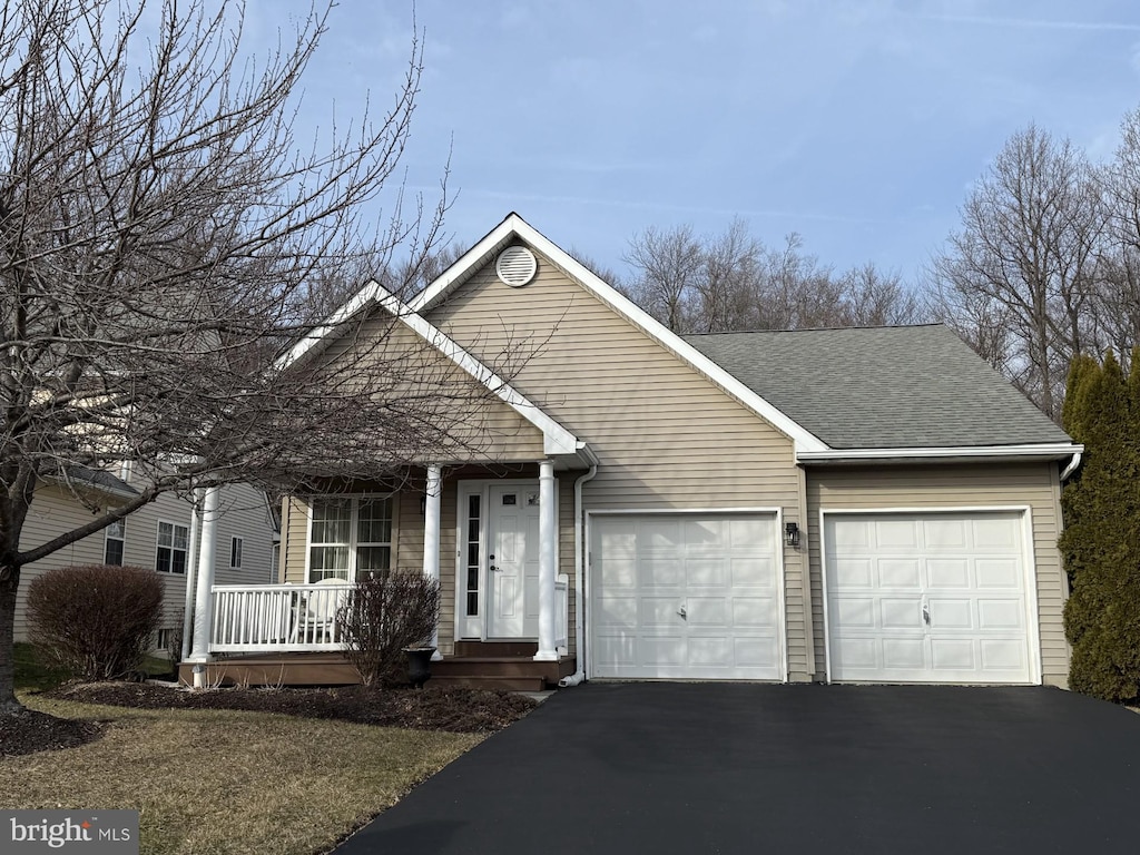 view of front of property featuring a garage and a porch