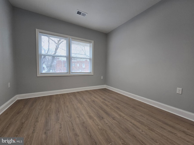 spare room with dark hardwood / wood-style floors