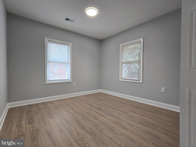 empty room with hardwood / wood-style flooring