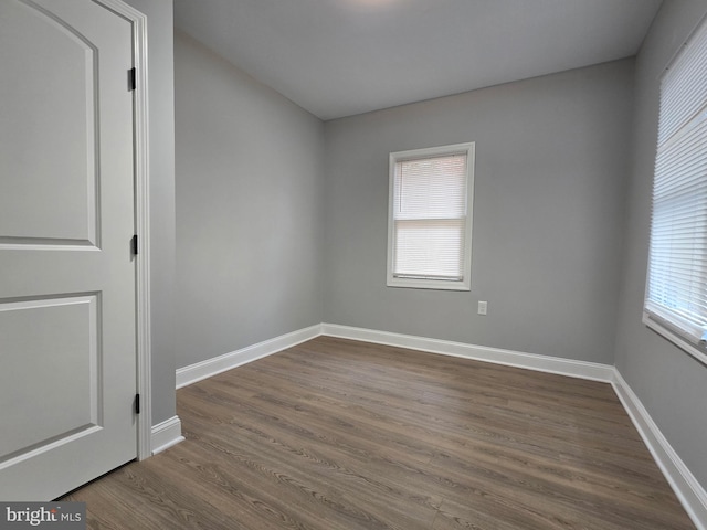 spare room with dark wood-type flooring