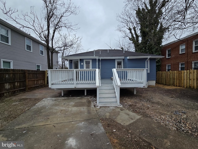 back of property featuring a wooden deck