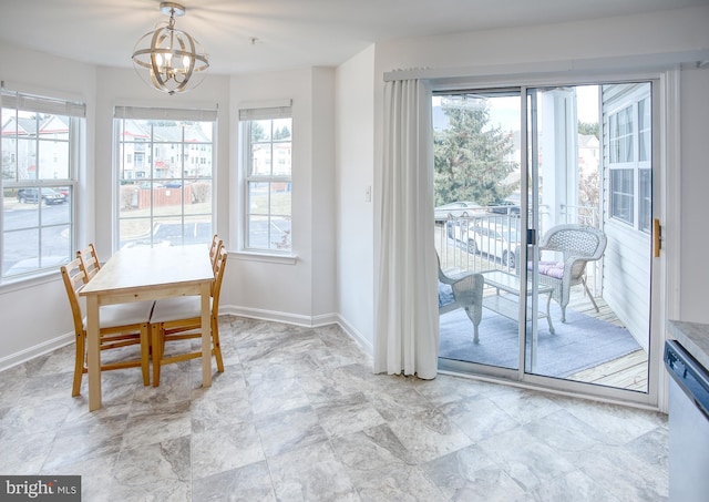 dining area with baseboards, a chandelier, and a healthy amount of sunlight