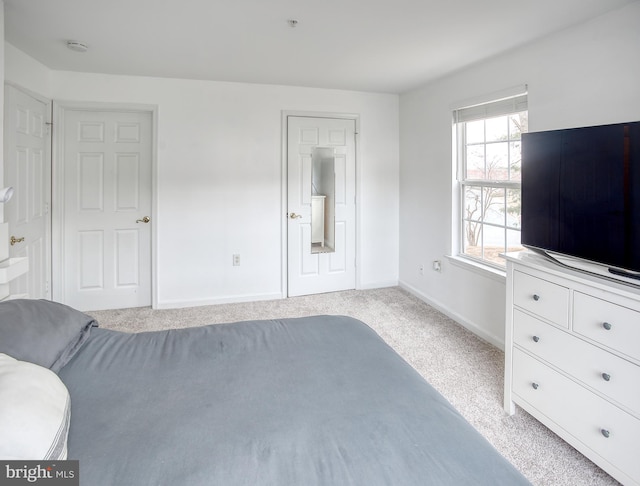 unfurnished bedroom with light carpet and baseboards