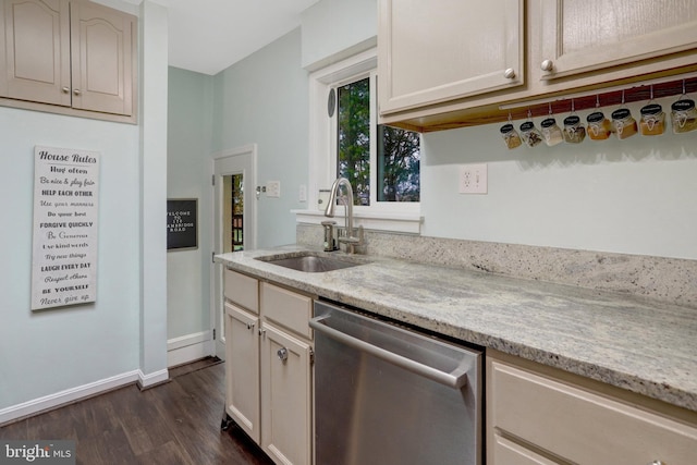 kitchen featuring a sink, dark wood-style floors, baseboards, light stone countertops, and dishwasher