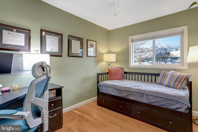 bedroom featuring wood finished floors and baseboards