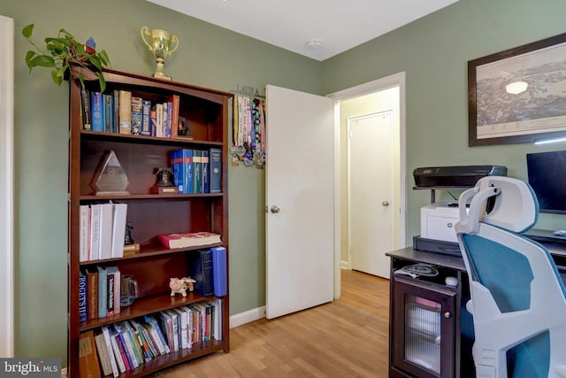 home office featuring baseboards and wood finished floors