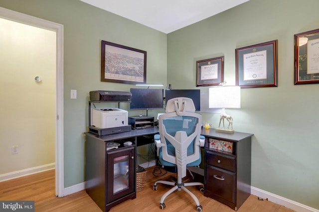 office space featuring light wood-style flooring and baseboards