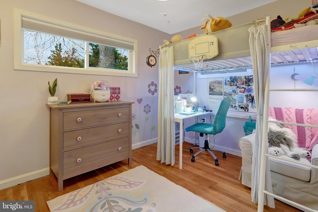 bedroom featuring baseboards and wood finished floors