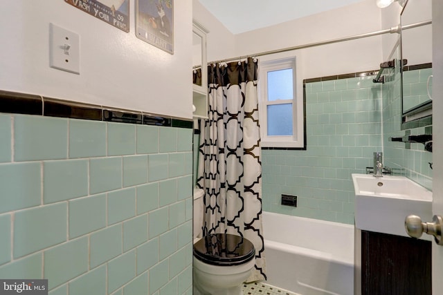 bathroom featuring shower / bathtub combination with curtain, tile walls, toilet, and vanity