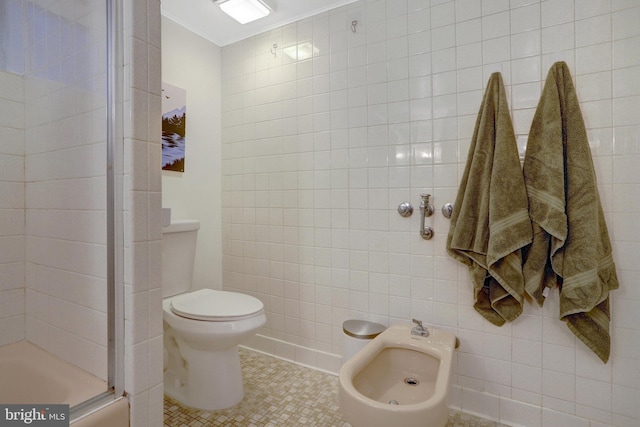 bathroom with toilet, a shower with shower door, tile walls, ornamental molding, and tile patterned floors