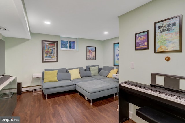 living room with a baseboard heating unit, recessed lighting, visible vents, and dark wood-style floors