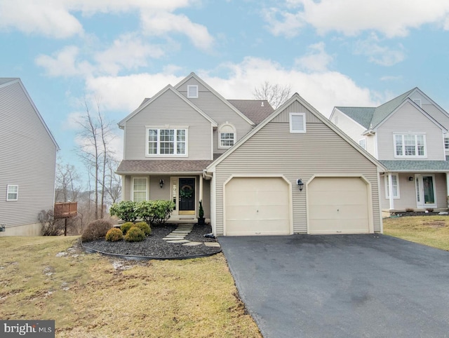 view of property with a garage and a front lawn