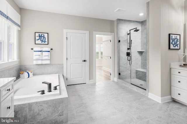 bathroom featuring vanity and shower with separate bathtub