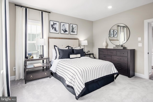 bedroom featuring light carpet