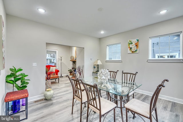 dining area featuring a healthy amount of sunlight and light wood-type flooring