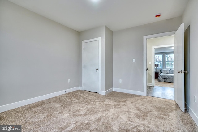 unfurnished bedroom with light colored carpet