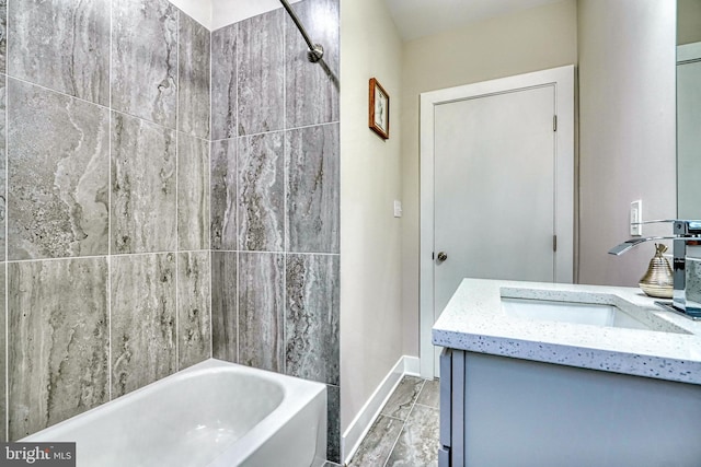 bathroom featuring vanity and  shower combination