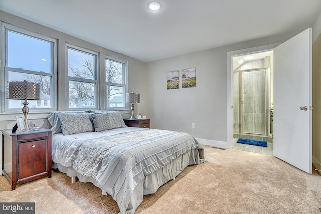 carpeted bedroom featuring ensuite bathroom