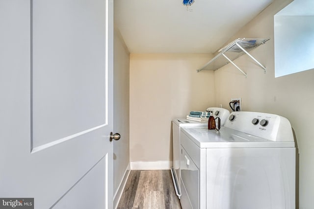 laundry area featuring hardwood / wood-style floors and washing machine and dryer