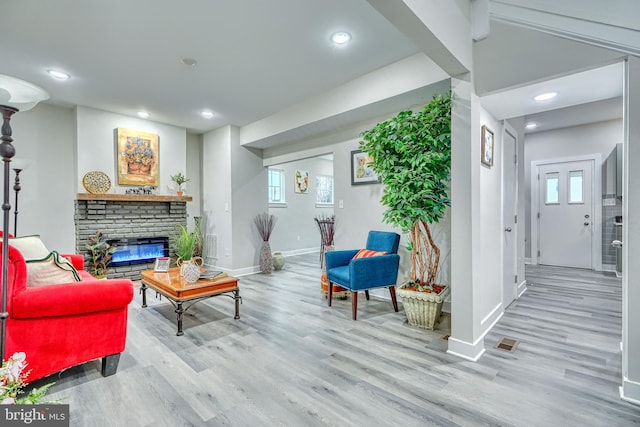 living room with a fireplace and light hardwood / wood-style floors