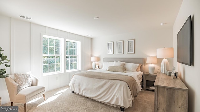 bedroom featuring light colored carpet