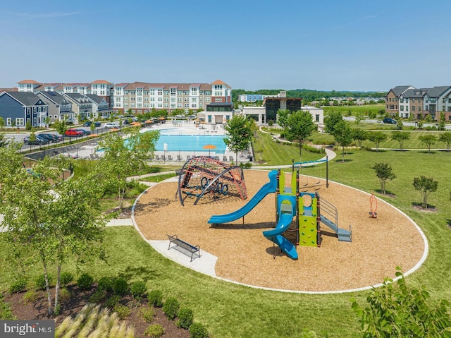 exterior space with a community pool and a lawn