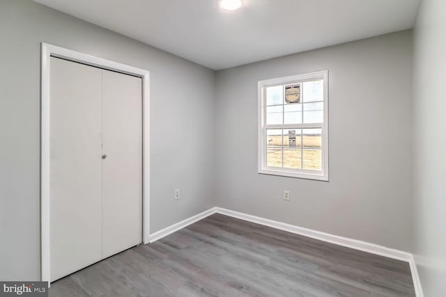 unfurnished bedroom with a closet and light hardwood / wood-style flooring