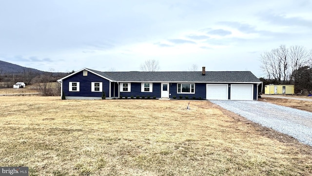 single story home with a garage and a front yard