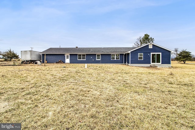 rear view of house with a yard