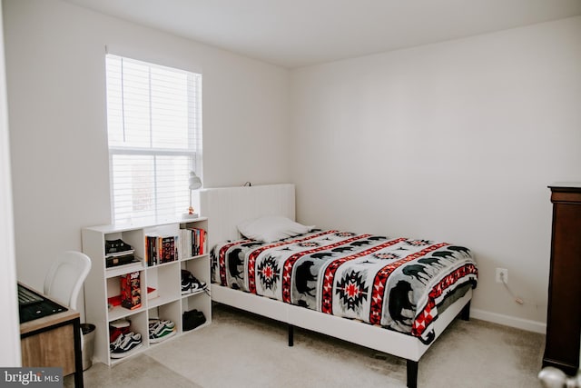 bedroom featuring light colored carpet