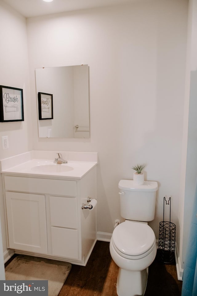 bathroom featuring hardwood / wood-style flooring, vanity, and toilet