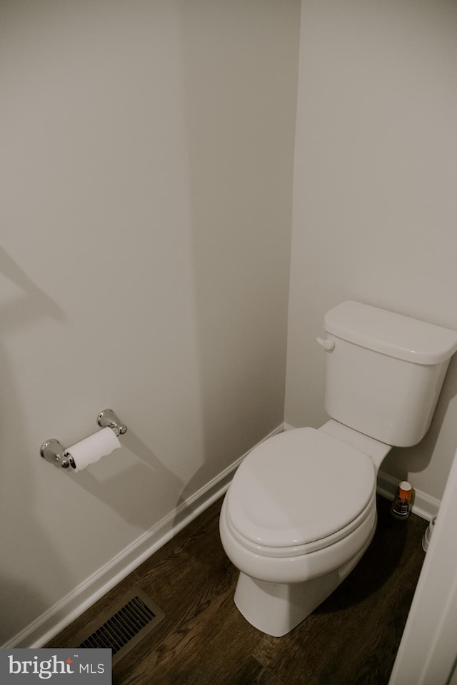 bathroom with wood-type flooring and toilet