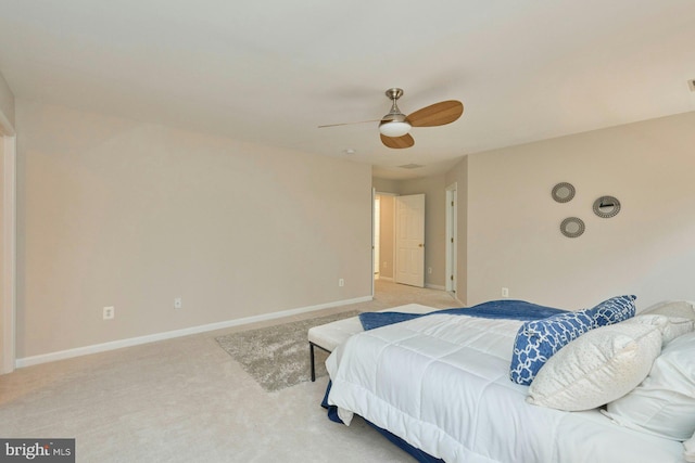 bedroom featuring light colored carpet, baseboards, and ceiling fan