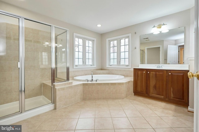 full bath with a stall shower, a bath, vanity, and tile patterned flooring