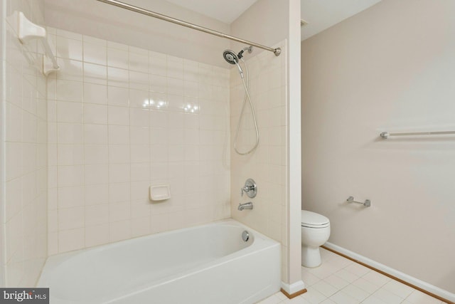 bathroom featuring tile patterned flooring, toilet, baseboards, and shower / washtub combination