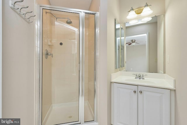 bathroom featuring vanity, ceiling fan, and a shower stall