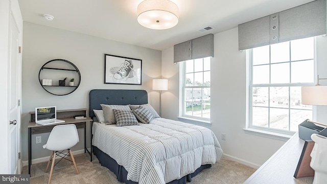 bedroom featuring light carpet